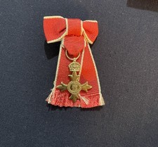 Miniature Order of the British Empire (OBE) medal on ladies bow ribbon
