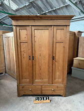 Waxed antique pine triple wardrobe with partition
