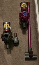 Two hand held Dyson vacuum
