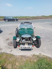 Lomax 223 three wheeler sports car with tonneau cover and hood .