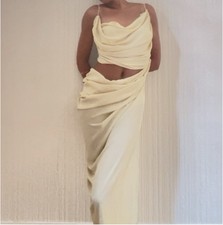 Draped dress, cowl neck and a draped, flowing silhouette that evokes a Grecian