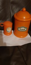 THE WORKING KITCHEN ORANGE FLOUR AND SHAKER CONTAINERS. FROM THE 1970s.