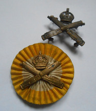 MGC   two collar badges of the MACHINE GUN CORPS one on yellow / white rosette