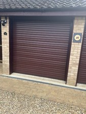 Two Mahogany Electric Roller Garage Doors