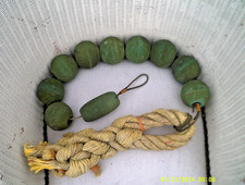 ROPE OF FISHING NET FLOATS AND INTRICATE BRAIDED ROPEWORK.