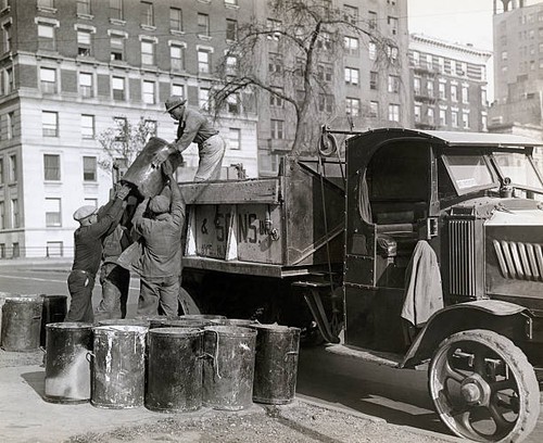 Sanitation workers lifting - , a