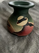 This is a hand-painted pottery vase, often referred to as Peruvian folk art