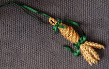 A small handmade Corn Dolly a straw gift with green satin ribbons & plaited loop