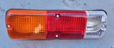 Unused replacement trailer rear light lens cluster, includes bulbs