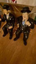 laurel and hardy statues and bench 