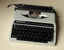 Silver Reed SR 100 Tabulator portable typewriter with case and spare ribbon