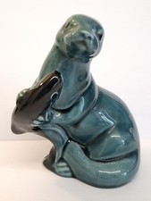 POOLE POTTERY OTTER HOLDING A