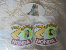 TWO HONDA WORLD CHAMPIONS STICKERS AND ONE ESSO PUT A TIGER IN YOUR TANK STICKER