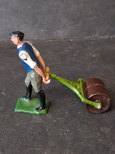 Man pulling garden roller - man,