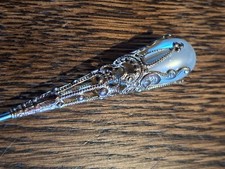 Antique hat pin with faux pearl and gold top.