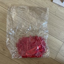 Hamper Shredded Red Paper And Small Bag With A Red Ribbon Used