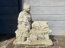 Vintage stone garden statue Elderly Lady Feeding Squrells on the bench.
