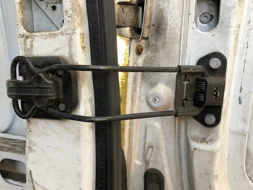 Rear door check - strap, release