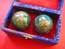 Baoding balls housed in a