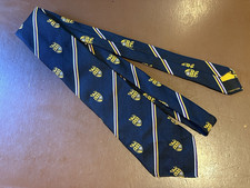 Unicol Tie-Lion with a Torch standing on a Shield Emblem 3 Stars, 2 Spires, Star