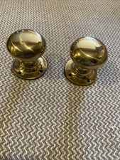 A PAIR OF RECLAIMED BRASS DOOR KNOBS