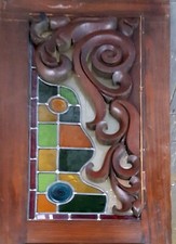 ORIGINAL STAINED GLASS PANEL WITH COLOURED RONDELS AND CARVED WOOD MOULDING