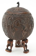 A 19th century South East Asian Carved Coconut, on tripod figural supports