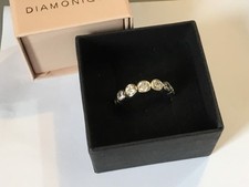 A pre owned Diamonique DQCZ 7 stone 925 ring size Q-R weight 5.2 gm
