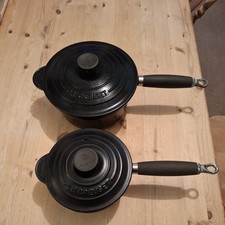 Le Creuset, Vintage Black Enamelled sauce pans with lids x 2 .
