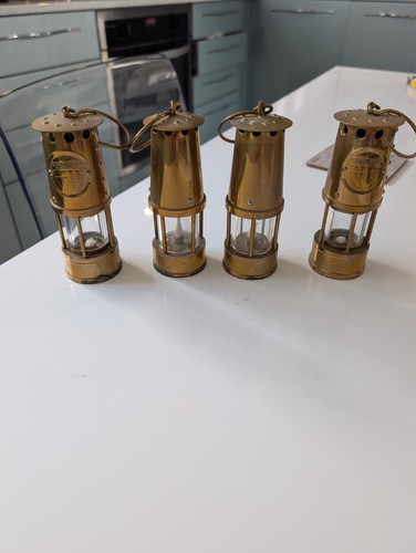 Four miniature brass miners - four,
