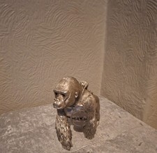 silver decorative gorilla with baby on back