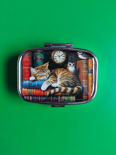 Metal pill box featuring cat - box,