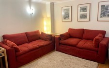 Pair of dark red Sofa Workshop sofas with washable cotton covers