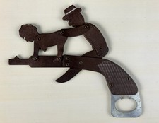 VTG Mechanical Sexy Couple Riding A Gun Brown Bakelite? Bottle Opener Argentina