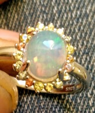 FIRE OPAL RING OVAL VVS.SURROUND BY MULTI-COLOURED SAPPHIRES 925. 9x7mm.SIZE 8.5