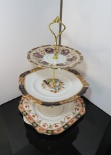 A Magnificent Three-Tier English Porcelain Service With A Metal Rod And Handle