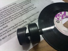 THE DINKER CUTS LARGE HOLES IN VINYL RECORDS FOR ALL JUKE BOX'S 45's SINGLES