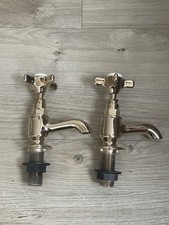 pair of brass bath taps from