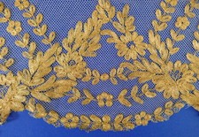 A LENGTH OF ANTIQUE GOLD HAND EMBROIDERED TULLE LACE