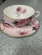 Wedgwood China Cuckoo design footed tea cup and saucer duo.
