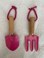 Kid's garden set of spade and fork in pink colour.