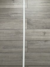 Easy to Install Floor Cover Strip Enhances and Protects Laminate Flooring