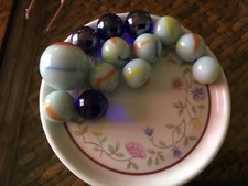 7 milky white ,4 dark blue 2 agate marbles,1 large 1 small in good condition