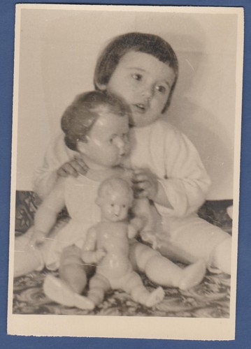 Beautiful baby with big dolls