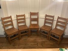 four matching solid oak kitchen chairs plus one 'daddy bear' chair