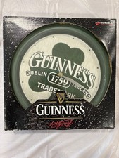 Guinness-branded wall clock with a shamrock design.