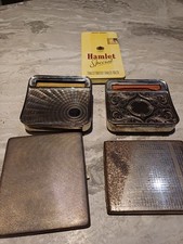 Vintage cigarette cases and rolling machines.