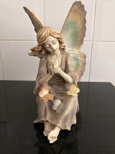 Fairy figurine holding and - fairy,