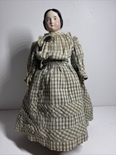 Antique China head doll with black banana curls, blue pin, leather arms & boots