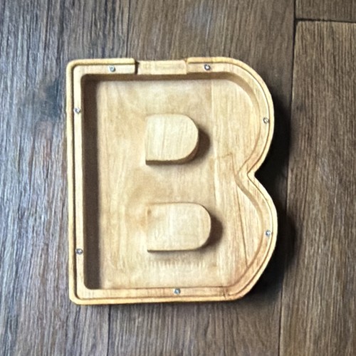 Wooden letter money box with - money,